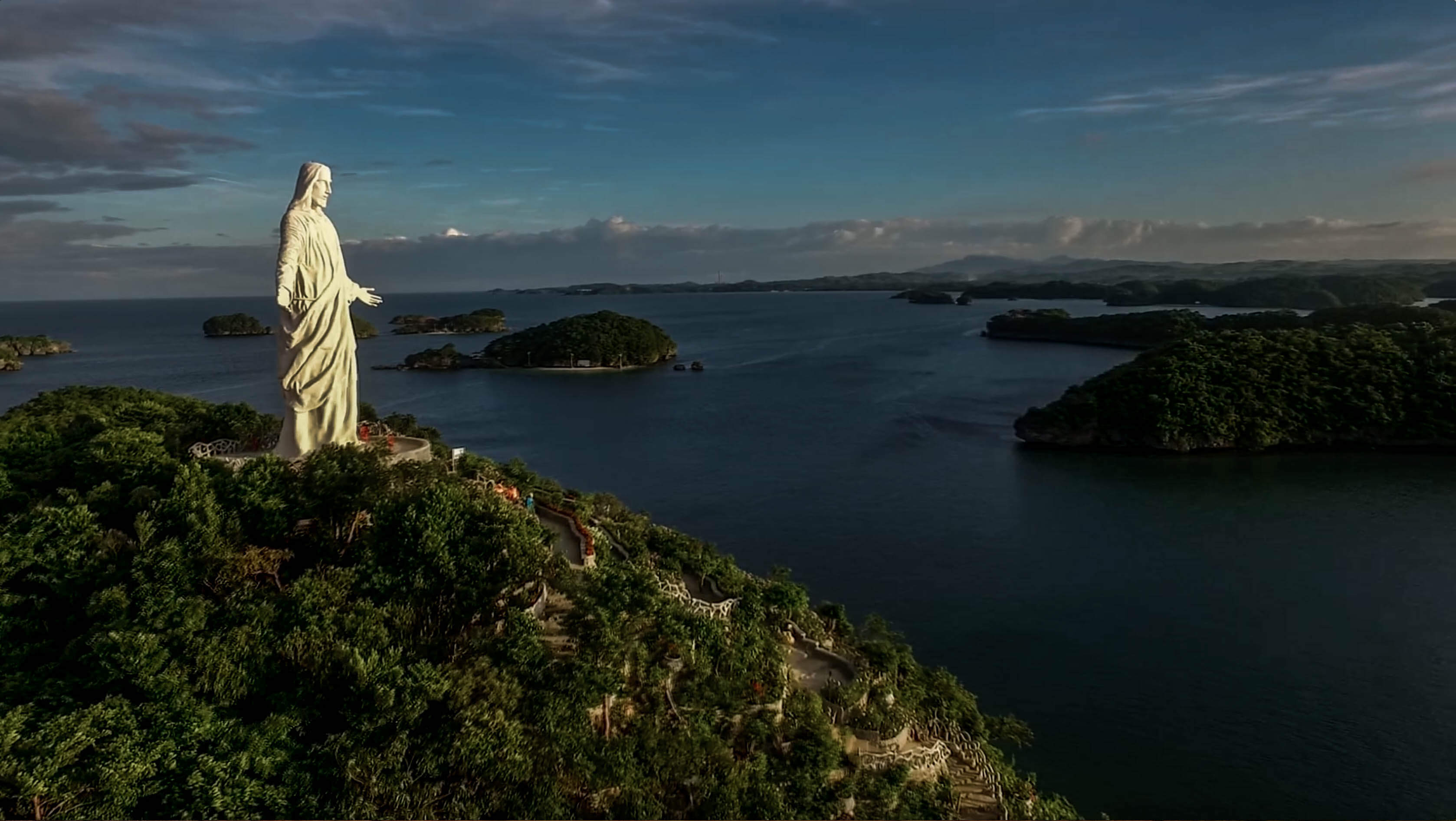 drone shot of pilgrimage island at with jesus statue at hundred islands nature park in pangasinan